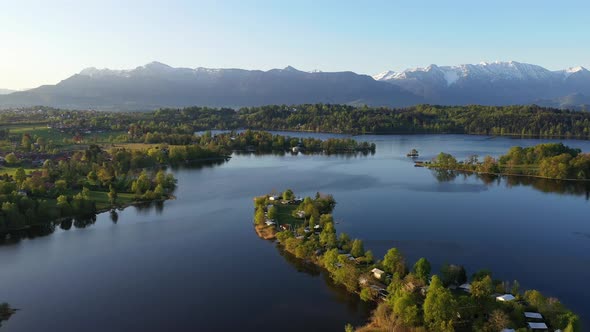 Flight over the campig island of Buchau in lake Staffelsee in Bavaria, Germany alt