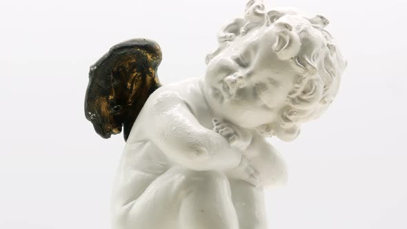 Beautiful Little Angel Statuette on a White Background 