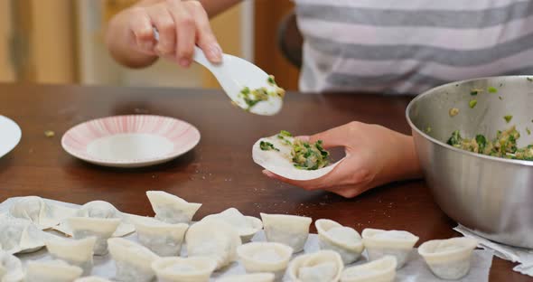 Woman make of chinese meat dumpling at home