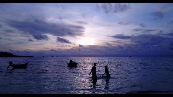 Guy and girl sunbathe on relaxing sea view beach wildlife by transparent lagoon and white sandy back alt