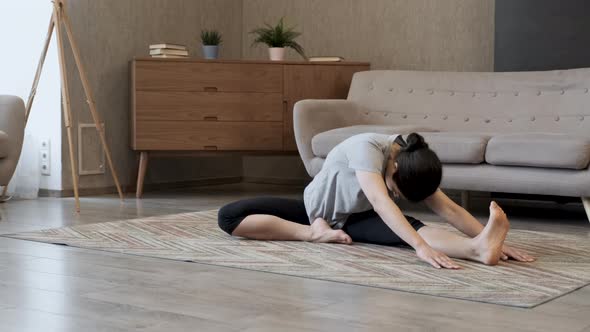 A young girl doing yoga in the asana pose. Attractive girl doing static exercise alt