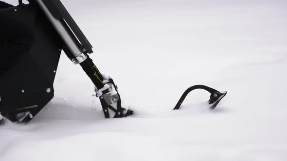 Snowbike Rides Through the Snowdrifts and the Snow Flies in Different Directions alt