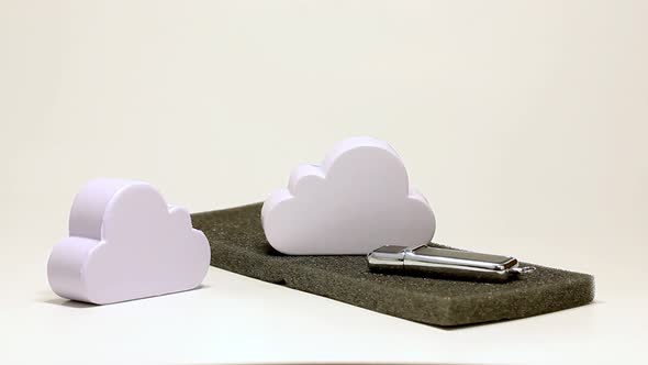 Building a cloud data storage model, hand putting simple cloud props together alt