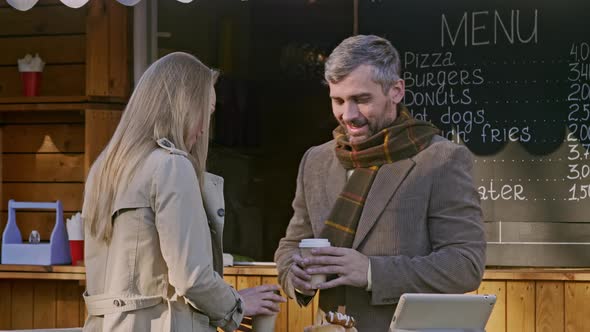 Man and woman drink coffee outdoor coffee shop