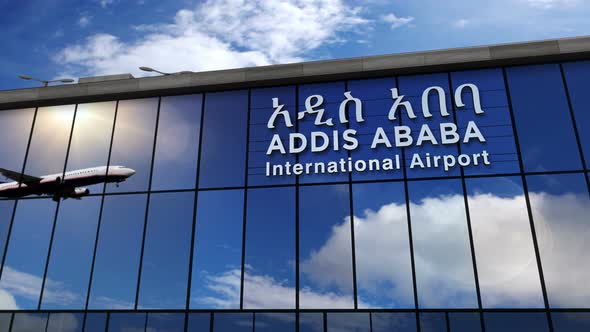 Airplane landing at Addis Ababa Ethiopia airport mirrored in terminal alt