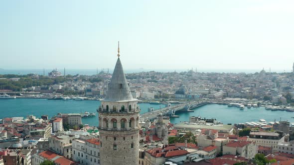 Passing Galata Tower Revealing Galata Bridge Over Bosphorus with Beautiful Clear Blue Sky, Slow alt