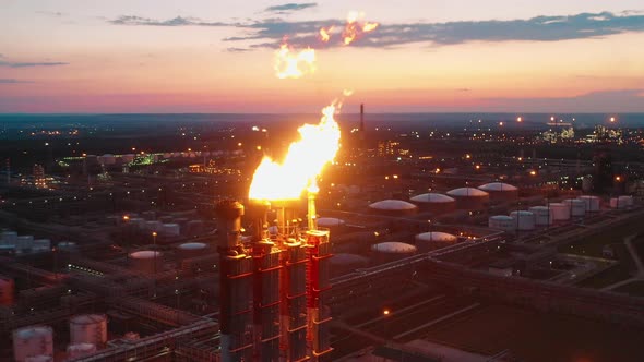 Refinery Gas Flares and Factory Constructions Filmed at Sunset alt