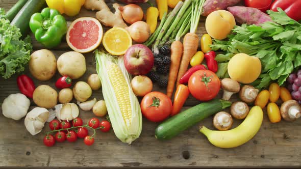 Video of fresh fruit and vegetables over wooden background alt
