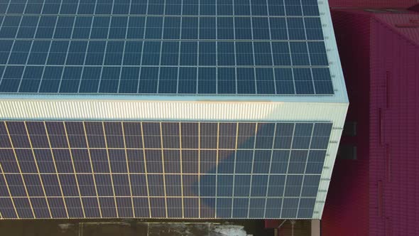 Blue photovoltaic solar panels mounted on building roof for producing clean ecological alt