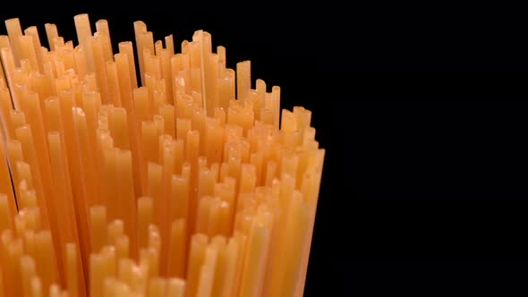 Spaghetti rotating on black background
