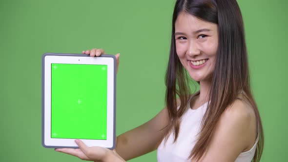 Young Beautiful Asian Businesswoman Showing Digital Tablet