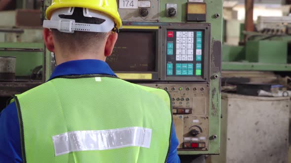 Group of Factory Workers Using Machine Equipment in Factory Workshop alt