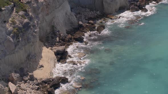 Flying Over Cliffs Cascading into the Ionian Sea Water Near Loutraki Greece alt