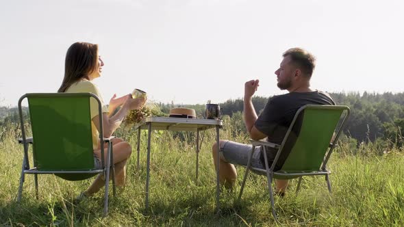 Middle Aged Couple Having Rest in Nature Sitting on Outdoor Chairs