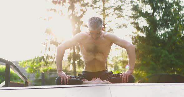 Shirtless Man Practicing Breathing Moving Stomach Muscles in Circles alt