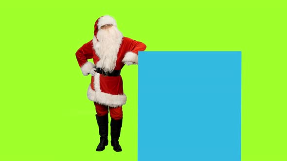 Santa Claus on Green Screen Points to Blue Screen, Chroma Key