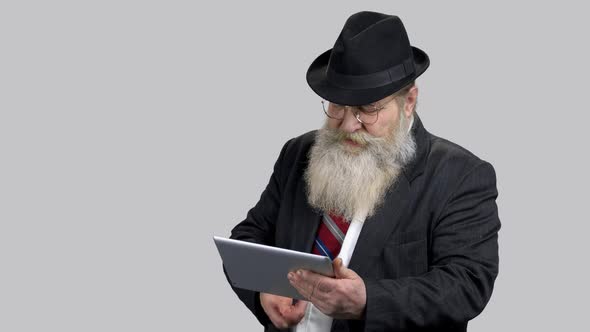 Old Businessman Swiping and Touching Tablet Pc Screen alt