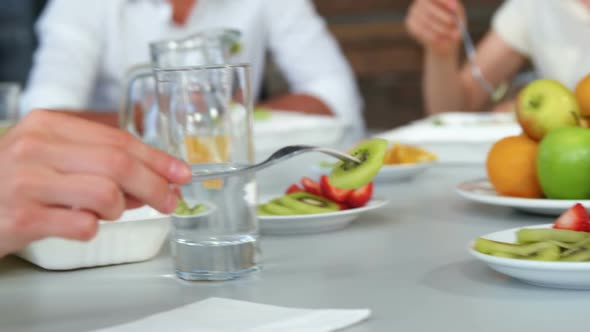 Group of business executives having breakfast alt
