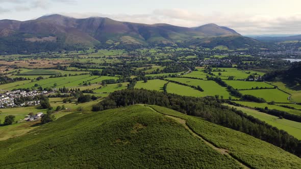 Looking towards Skiddaw and Belcathra from Barrow in the Lake District. Aerial footage from a drone. alt
