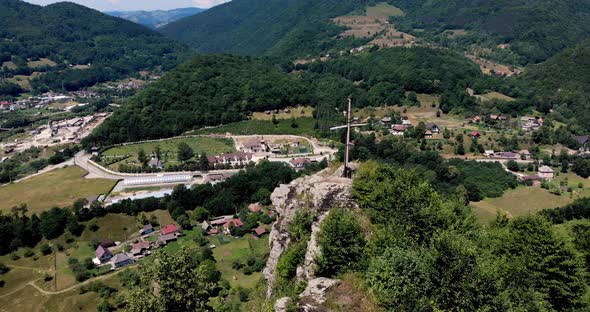 Summit Cross At The Apuseni Mountains With A View Of Village Near Aries River alt