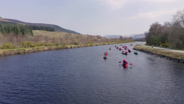 Low and Fast Aerial Shot of A Group of Canoeists Travelling Along a Canal alt