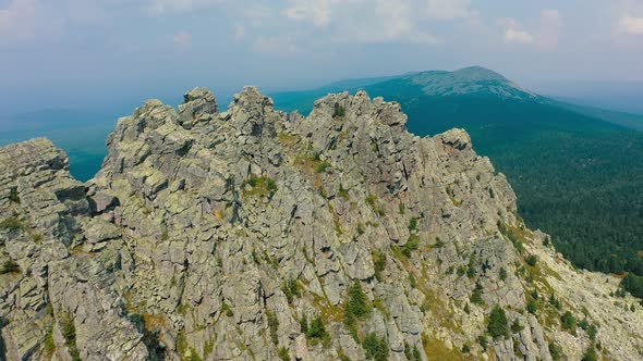 Aerial Huge Mountain Range with Steep Cliff Slopes Bare Rocks Panoramic View alt