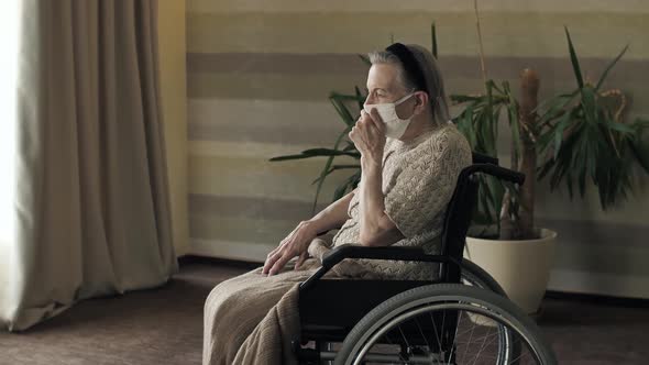 Old Woman in Face Mask Coughing alt