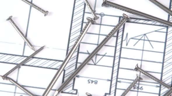 Metal Nails on Building Plan, Close Up, Rotation alt