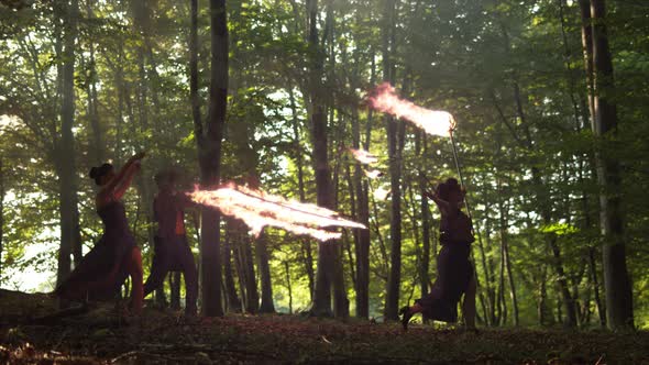 Male and female artists holding fire staffs, Ultra Slow Motion alt
