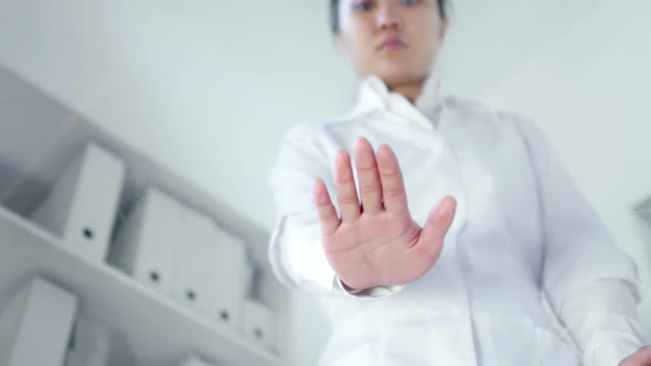 Female Scientist Pressing Palm on Interactive Transparent AR Screen alt