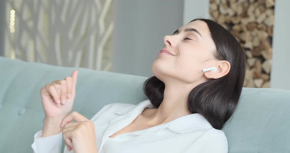 A Beautiful Girl Listens to Relaxing Music on Her Phone and Gets Excited By the Pleasant Vibes alt