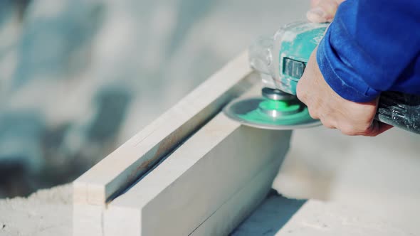 The master works with a stone using a grinder. Polishing and grinding of stone products alt