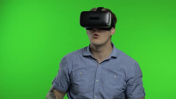 Man Using VR App Helmet To Play Simulation Game, Drawing. Guy Watching Virtual Reality 3d Video alt