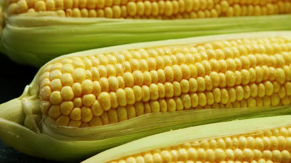 Fresh Maize in Leaves on the Table alt