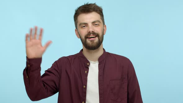 Slow Motion of Cheerful Man with Beard Saying Hi Waving Hand in Hello Gesture