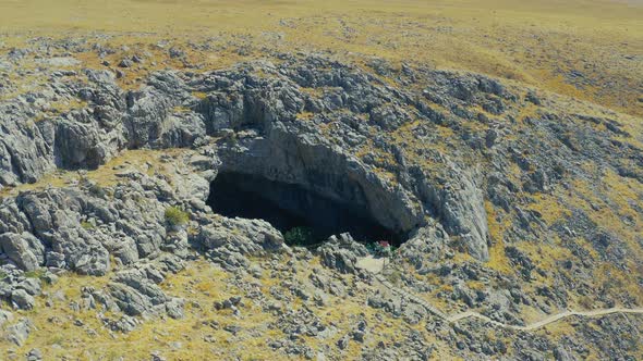 Around Sinkhole AkMechet Cave with Trees Inside in Kazakhstan Mountain alt
