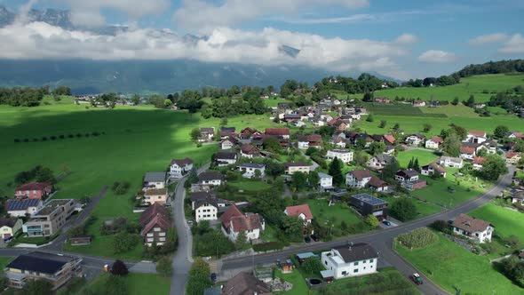 Aerial View of Liechtenstein with Houses on Green Fields in Alps Mountain Valley alt