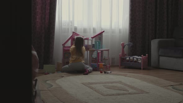 Little Girl in Pajamas Playing Alone in the Room