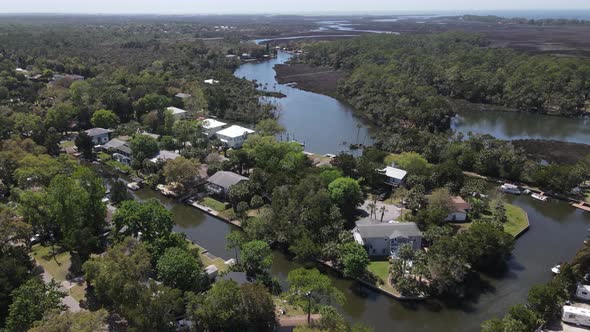 aerial of homes on the canals at the start of the wider portion of the Weeki Wachee River in Florida alt