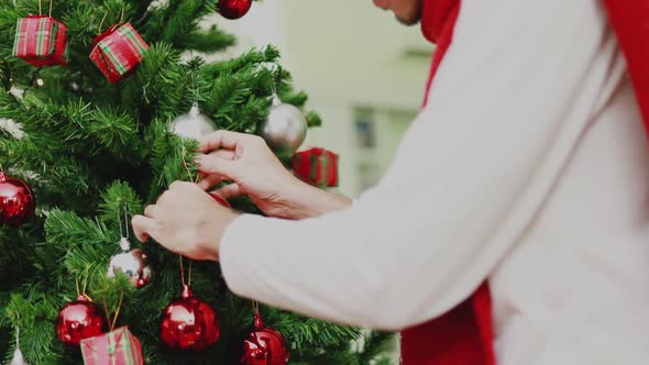 Close up Asian man holding red ball Christmas decorate Christmas tree celebrates the new year.