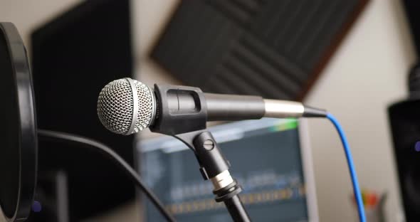 A vocal microphone and pop filter for singing or recording a podcast in a bedroom music studio SLIDE alt