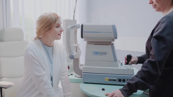 Doctor Testing for Eyes with Special Optical Apparatus in Modern Clinic alt