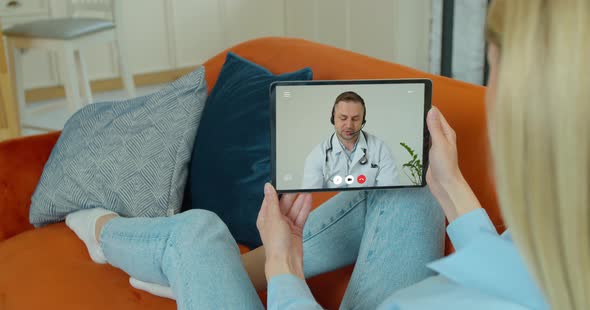 Beautiful Woman Checks Possible Symptoms with Professional Physician, Using Online Video Chat. Young alt