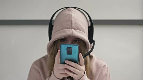 Teenager Looks at the Smartphone Screen Without Looking Up alt