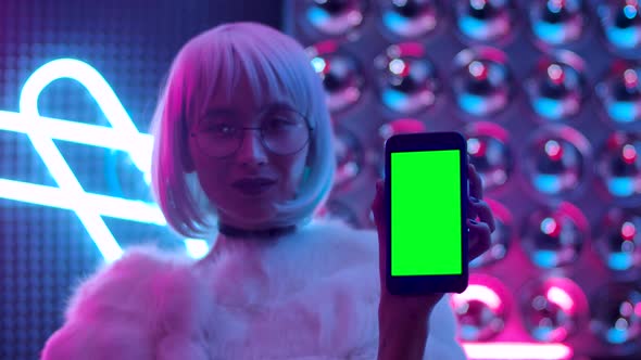 Stylish Person Hand Holding a Mobile Telephone with Green Screen Mockup Display