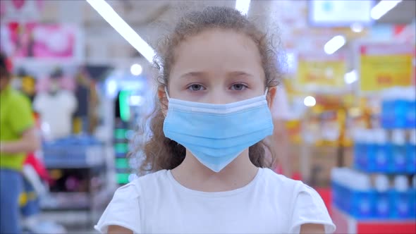 Portrait Child in Store in a Protective Medical Mask in a Terrible Epidemic of Coronavirus or alt