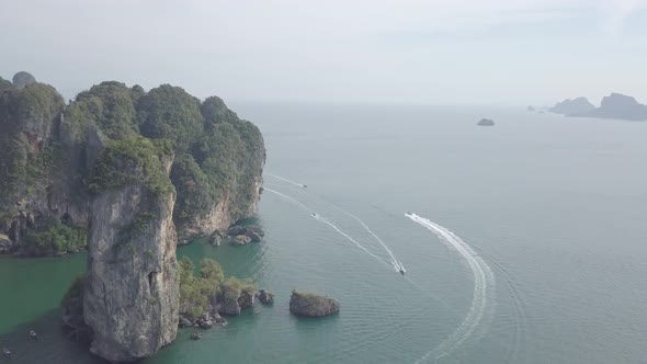 Aerial footage of Ao Nang beach, limestone rocks in sea, sailing boats, Krabi province, Thailand