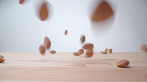 Slow Motion Drop and Almonds on the Table Closeup alt