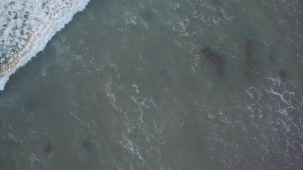 Aerial shot of the advance of the waves on the coast of Mexico