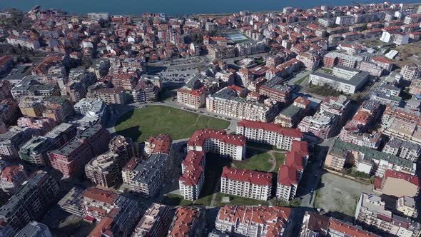 View From a Height of the City of Pomorie with Many Cars Houses and Hotels alt